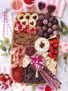 a platter filled with lots of different types of snacks and desserts on top of a table