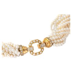 Cultured Pearl Necklace with 10 strands of pearls holding a 18K yellow gold clasp set by 28 round cut diamond and 8 baguette cut diamonds. The strands of lustrous pearls create a luxurious and voluminous cascade, framing the neckline with timeless elegance. At the forefront of this statement piece is the 18K yellow gold clasp, a work of art in itself. The clasp is embellished with a combination of 28 round-cut diamonds and 8 baguette-cut diamonds, totaling an impressive 1.13 carats. The diamonds, carefully selected for their brilliance, add a captivating sparkle to the ensemble. This Cultured Pearl Necklace with its Diamond Yellow Gold 18K clasp is not just a piece of jewelry; it is a celebration of the enduring allure of pearls and the timeless beauty of diamonds, making it a cherished ad Luxury Yellow Gold Beaded Necklace, Luxury Yellow Gold Pearl Necklace With Diamond Accents, Luxury Yellow Gold Pearl Necklace With Delicate Chain, Luxury Gold Beads Necklace For Celebration, Luxury Yellow Gold Pearl Necklace With Cable Chain, Gold Pearl Jewelry Necklace 1stdibs, Luxury Yellow Gold Pearl Necklace For Festive Occasions, Luxury Yellow Gold Pearl Necklace, Luxury Yellow Necklaces With Pearl Pendant