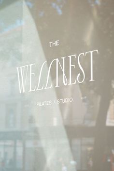 the front window of a building that says, the weelanest pilates / studio