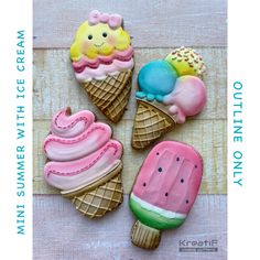 four decorated ice cream cookies sitting on top of a table