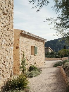 an old stone building with green shutters