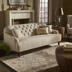 a living room filled with furniture and a fire place in the middle of the room