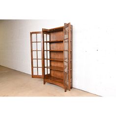 an open wooden bookcase sitting on top of a floor