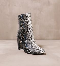 Snake room in your closet and let these boots slither on in. These statement boots by Chinese Laundry feature a multi-toned python print with pops of color to add dimension. With a block heel, an almond toe, and a side zipper, these shoes exude fun energy in a classic silhouette. 3.5" Heel l Manmade Materials l True to Size Snake Room, Statement Boots, Unique Boots, Unique Fall, Toes Designs, Python Print, Almond Shaped, Chinese Laundry, Opening Soon