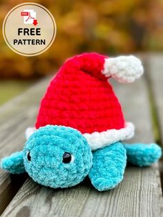 a crocheted blue and red turtle with a santa hat on it's head