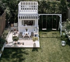 an aerial view of a backyard with a swing set, table and chairs in it