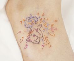 a person with a tattoo on their foot that has confetti sprinkles all over it