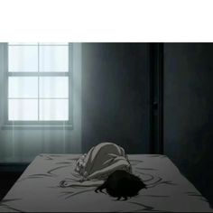 a person laying on top of a bed under a window in a dark room with light coming through the window