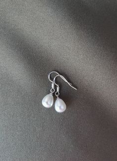 Beautiful earrings handmade with stamped 925 silver ear wires and faux teardrop-shaped pearls. Teardrop Pearl Earrings Gift, Gift Pearl Drop Teardrop Pendant Earrings, Pearl Drop Teardrop Pendant Earrings As Gift, Pearl Teardrop Earrings With Ear Wire, Teardrop Pearl Earrings With Ear Wire, Teardrop Pearl Earrings For Pierced Ears, Pearl Drop Teardrop Pendant Earrings For Gift, Minimalist Hypoallergenic Teardrop Pearl Earrings, Pearl Teardrop Earrings As Gift