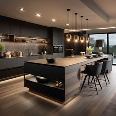 a modern kitchen with an island counter and bar stools next to the window that looks out onto the outdoors