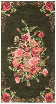 a green rug with pink and red flowers on it