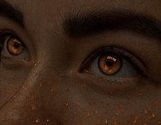 a woman's face is covered in brown speckles and has her eyes open