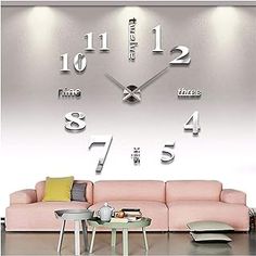 a living room with a pink couch and large clock on the wall in front of it