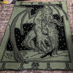 a crocheted rug with an image of a woman on it