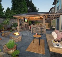 an outdoor living area with fire pit and grill