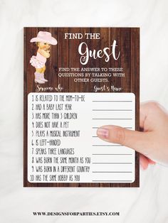 a hand holding up a wooden sign with the words find the guest