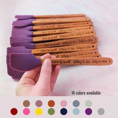 a hand holding six wooden pencils with writing on them and the words love is sweet in different colors