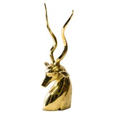 a golden statue of an antelope on a white background