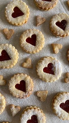 heart shaped pastries are arranged on a sheet of paper with hearts cut out in the middle