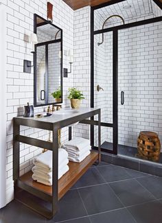 a bathroom with black and white tiled walls