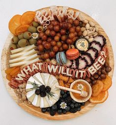 a wooden plate topped with lots of different types of food