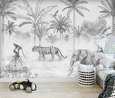 a bedroom with a tiger and monkey wallpaper in the corner, next to a toy car