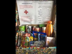 a basket filled with lots of different types of food and drinks next to a sign