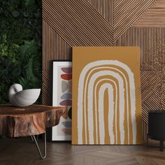 an abstract painting on the wall next to a wooden table