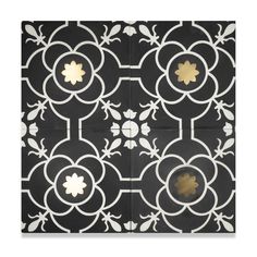 a black and white tile with gold flowers on the center, in an ornate pattern