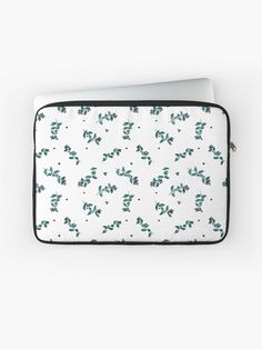 a white laptop case with green leaves on it