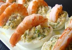 deviled eggs stuffed with shrimp and mayonnaise are ready to be served on a platter