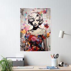 a painting of a woman with flowers in her hair on a wall above a desk