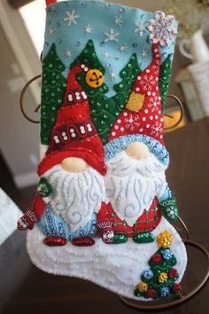 This is an approximate 18 inch, "GNOMES" felt stocking. The stocking was done all by hand and is made from a Bucilla kit. The stocking is made with felt, beads, sequins and embroidery thread. This stocking is a great addition to your holiday decor and  features a festive design of colorful Gnomes, adding unique design features to the beloved characters. The lightly stuffing gives it a 3D effect. I also added my own touch to the tree by adding additional bling! These stockings take many hours to make, and I sew every sequin and bead 2-3 times for added strength. They are lined with complementary color fabric for added strength and to prevent stretching.  I have added a name tag which, once personalized, can be attached to stocking hanger. Bucilla Felt Stocking Kits, Felt Stocking Kit, Felt Stocking, Felt Beads, Stocking Hanger, Tree Decorating, Festive Design, 3d Effect, Color Fabric