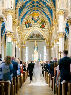 a bride and groom walking down the aisle at their wedding ceremony in st louis cathedral