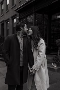 a man and woman kissing on the street