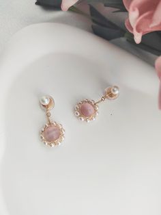 A pair of 14K gold cute and nicely freshwater pearls with pink crystal drop clip on earrings. Lightweight invisible clip on earrings for non pierced ears and sensitive ears. Materials: 14K Gold, Copper, Pink Crystal, Pearl  Size: 1.4in/3.5cm Style: Minimalist 100% Handmade Jewelry Perfect gift for friends/girlfriend/wife and yourself They will arrive packaged in lovely jewellery bag. Please mark as a gift when you need gift box packaging About me and the shop: As the owner of this little shop, I Pink Feminine Dangle Pearl Earrings, Pink Dangle Clip-on Jewelry, Pink Clip-on Dangle Jewelry, Pink Pearl Earrings For Pierced Ears, Elegant Pink Dangle Clip-on Earrings, Pink Pearl Earrings For Gift, Pink Pearl Round Earrings, Pink Clip-on Drop Earrings, Pink Feminine Pearl Earrings