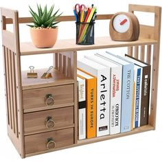 a wooden book shelf with two drawers and books