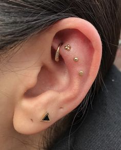 an ear with three different piercings on it