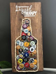 a wooden sign with a bottle filled with bottles on it and the words liquor therapy written in