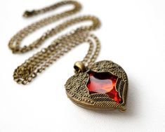 Get 15% off your order when you buy any 2 items in my shop! Vintage Jewelry, Red Heart Locket Necklace, Angel Wings, Red Crystal, Long Antiqued Bronze Chain, Love Gift, Christmas Gift for her This heart locket can't open, the red crystal is locked inside this ornate locket, with angel wings wrapping around the crystal. The necklace is from my private collection of 80s necklaces. It is in the perfect condition. More Fun Exciting Vintage Treasures here: http://www.etsy.com/shop/atVintage Red Heart Charm Necklace For Wedding, Personalized Red Jewelry For Anniversary Gift, Valentine's Day Red Heart Necklace, Red Locket Jewelry For Valentine's Day, Red Locket Necklace For Wedding, Red Heart Pendant Necklace For Wedding, Red Double Heart Necklace For Wedding, Red Necklace For Valentine's Day Anniversary, Red Necklace For Anniversary Gift On Valentine's Day