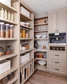 an organized pantry with lots of food in the cupboards and bowls on the shelves