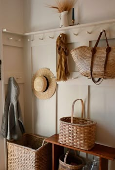 baskets and hats are hanging on the wall