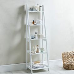 a white shelf with towels and other items on it