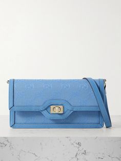 Gucci's 'Luce' shoulder bag has been made in Italy from canvas-jacquard featuring the label's signature 'GG' monogram. Trimmed with leather, it has a slim, elongated silhouette with enough space inside for your phone, cardholder and keys. Detach the striped webbing strap to carry yours as a clutch. Gucci Blue Shoulder Bag With Removable Pouch, Blue Gucci Shoulder Bag For Formal Occasions, Formal Blue Gucci Shoulder Bag, Gucci Blue Shoulder Bag With Detachable Strap, Blue Gucci Shoulder Bag With Detachable Strap, Blue Gucci Shoulder Bag For Evening, Blue Gucci Evening Shoulder Bag, Blue Gucci Travel Bag, Classic Blue Gucci Shoulder Bag