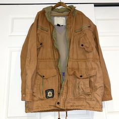 VINTAGE PREOWNED MEN’S BOAT WORKS CARGO PARKA JACKET SIZE L. such a cool find vintage cargo parka by the brand Navigation Boat Works orange brown outside with mesh lining green trim inside with drawstring bottom hood that can be taken out or packed inside multiple pockets some signs of wear but jacket is very much intact Men’s size Large polyester, cotton, nylon blend material photos depict condition Winter Cargo Style Long Sleeve Parka, Brown Utility Parka With Pockets, Utility Cargo Style Long Sleeve Parka, Utility Cargo Style Parka With Long Sleeves, Casual Cargo Style Parka With Long Sleeve, Vintage Outerwear With Cargo Pockets For Outdoor, Brown Long Sleeve Utility Parka, Vintage Utility Jacket With Multiple Pockets For Streetwear, Vintage Utility Jacket With Cargo Pockets For Streetwear