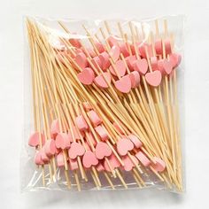 pink heart shaped lollipop sticks in plastic bag