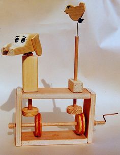 a wooden toy with wheels and a dog head