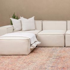 a large white couch sitting on top of a rug