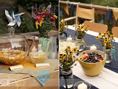 there are flowers in vases on the table and plates with food on it, along with other decorations