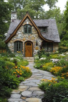 Cottage surrounded by lush gardens and stone pathway. The undeniable charm of cottage homes brings a rustic fairytale to life with each brick and beam.